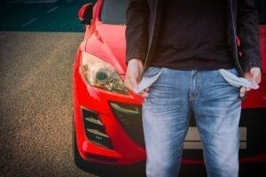 Man standing in front of car with no money