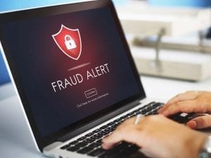 Fraud Alert on a computer front of man