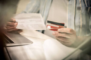 Man opening new credit card and examining the terms