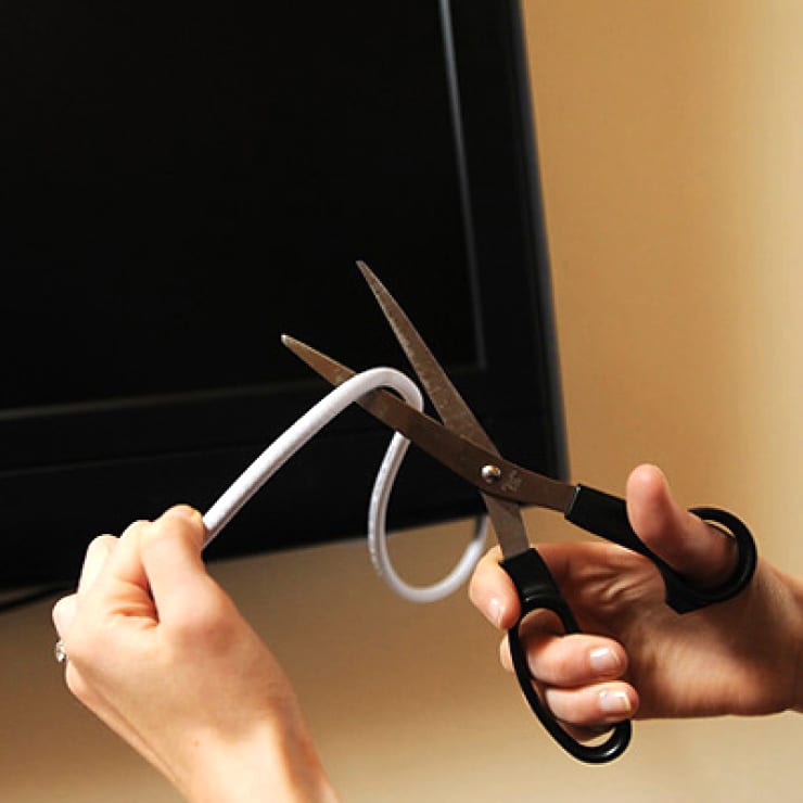 Scissors cutting a cable cord