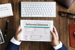 Man reading debt settlement statement on tablet