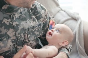 Military father holding his new born baby