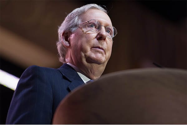 Senator Mitch McConnell at a podium