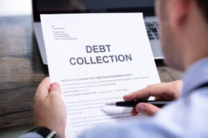 Man looking at debt collection paperwork