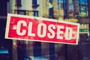 Closed sign on small business that declared bankruptcy