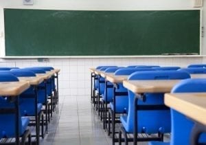 empty desks in front of chalkboard