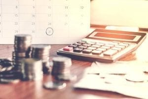 Tax date and calculator with money on a table